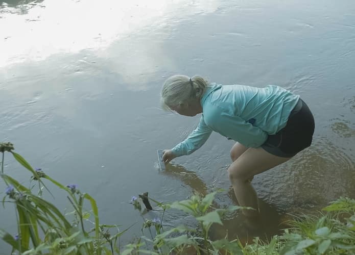 Ann conducting water quality testing